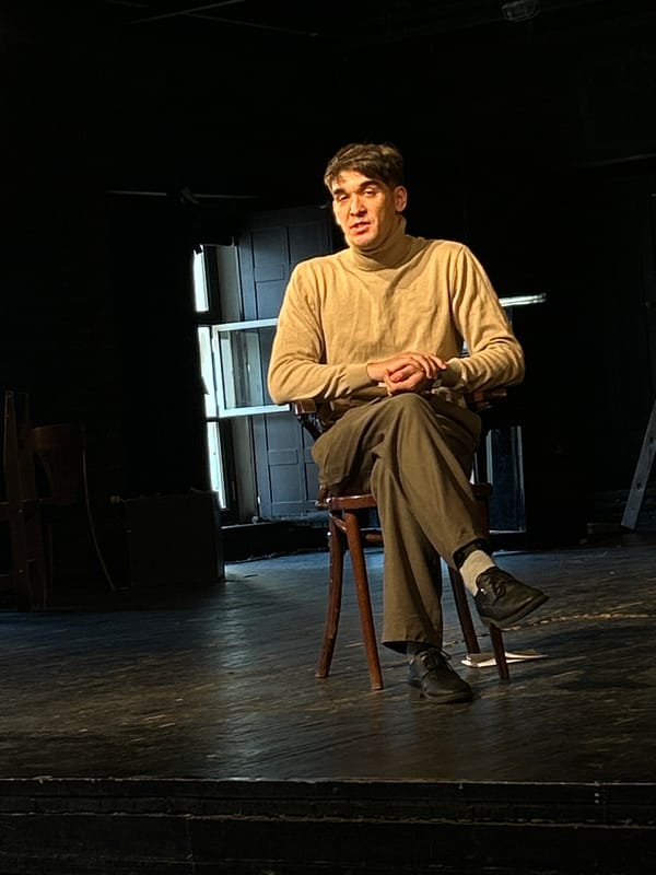 Young man photographed in dimly lit rehearsal space