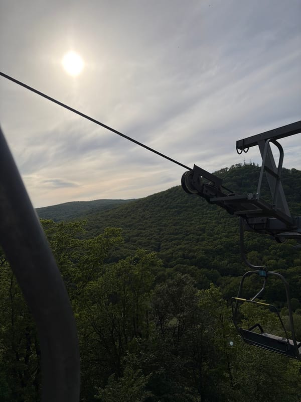 Chairlift operates over wooded mountains in Goryachiy Klyuch, Russia
