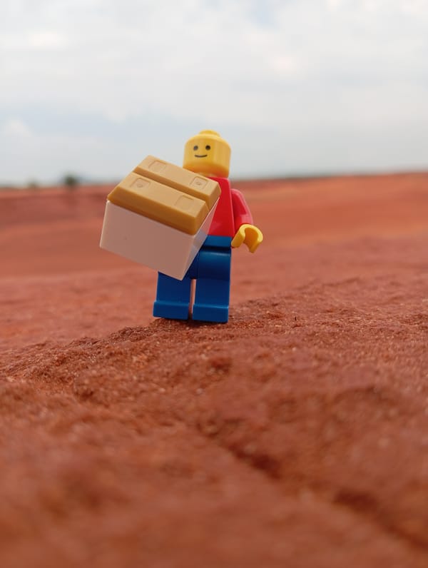 Lego figurine positioned on red soil in Phan Thiet