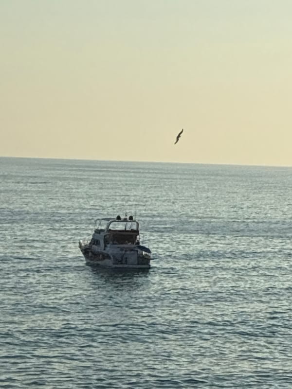 Alanya coastline: boats, beaches, and a burning vessel