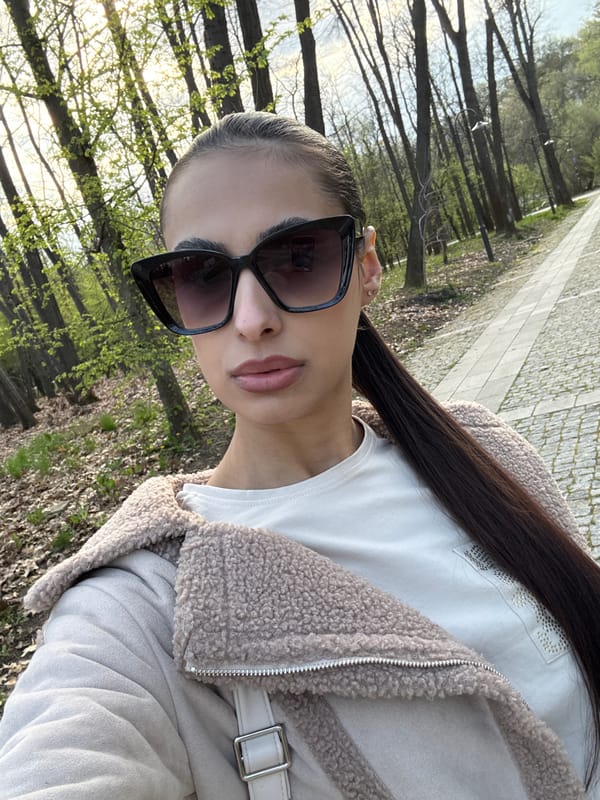 Woman walks tree-lined park path in Sofia