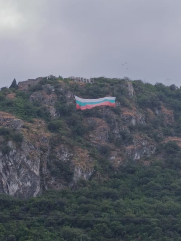Bulgarian flag on a hillside, glitter nails on a tabletop