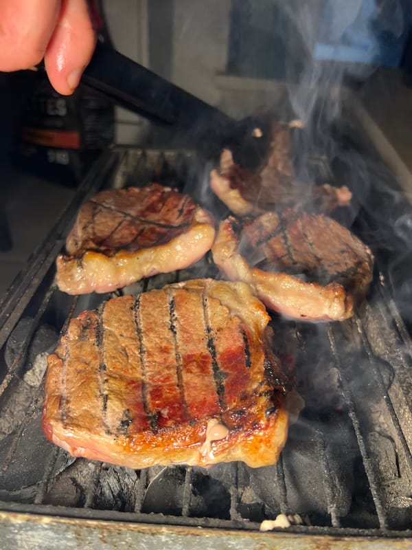 Steaks grilling on charcoal barbecue in Kiryat Bialik