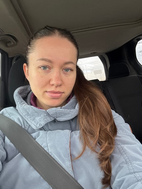 Woman and child photographed in car in Lipaki, Russia