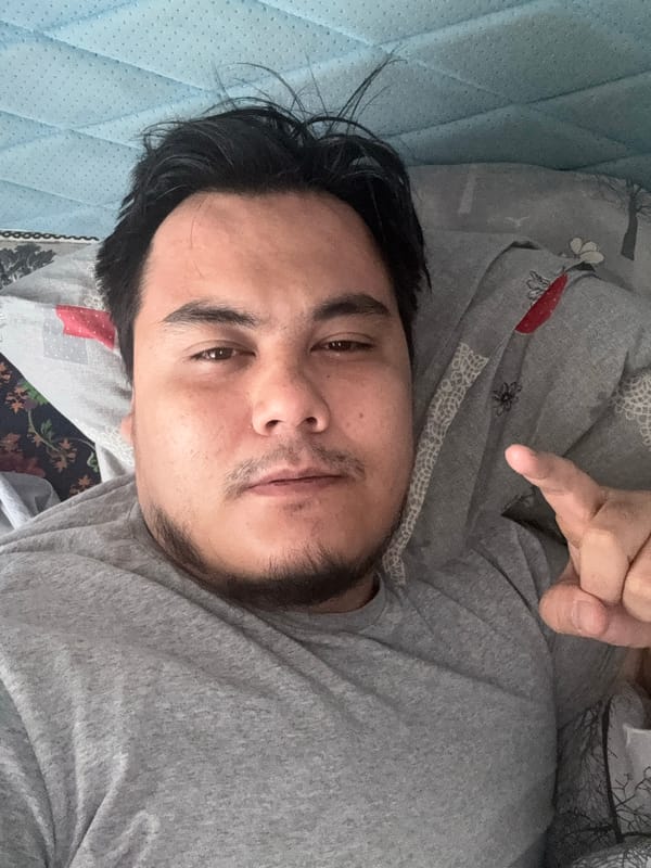 Casual indoor selfie from a bed in Chirchik, Uzbekistan
