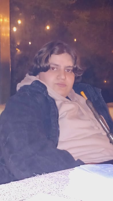 Young men socialize, smoke hookah in Damascus evening gathering
