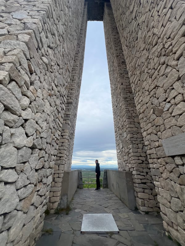 Tourist documents historic stone monuments in Perushtitsa, Bulgaria