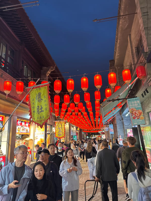Bustling crowds enjoy lantern-lined streets, dining in Beijing's Dongcheng District