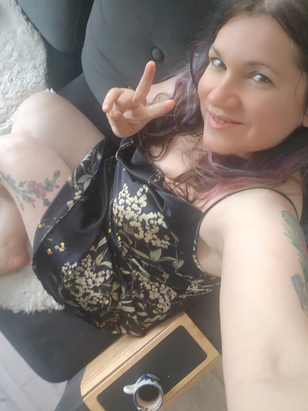 Relaxed at-home selfie session on a grey sofa, Russia
