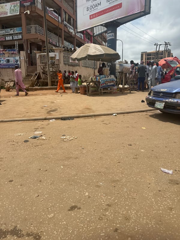 Keke NAPEPs and street traffic at an Abuja intersection