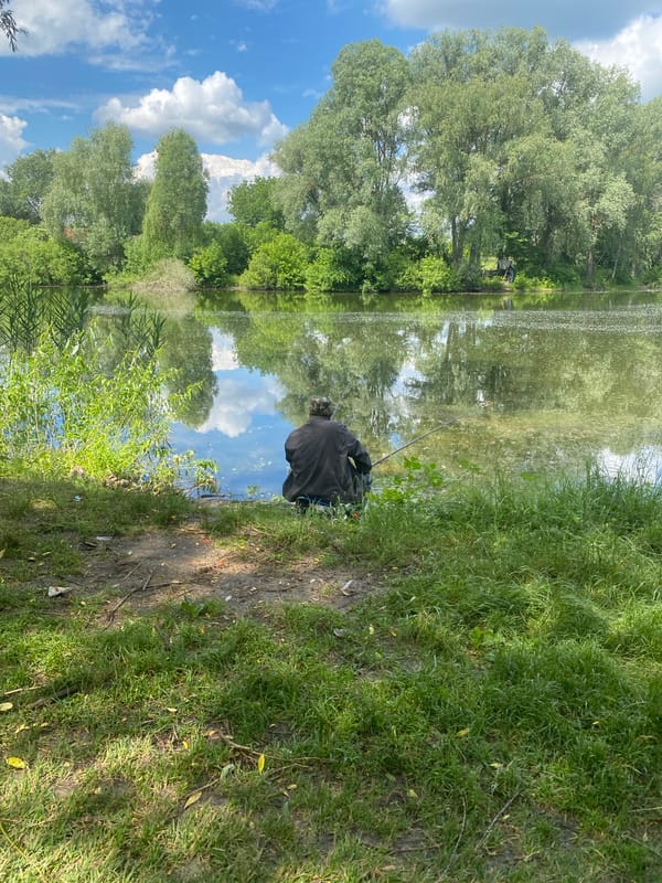 Elderly fisherman enjoys peaceful morning at Luka lake