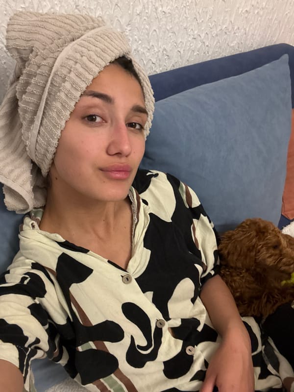 Woman rests with towel-wrapped head in Sutomore bedroom