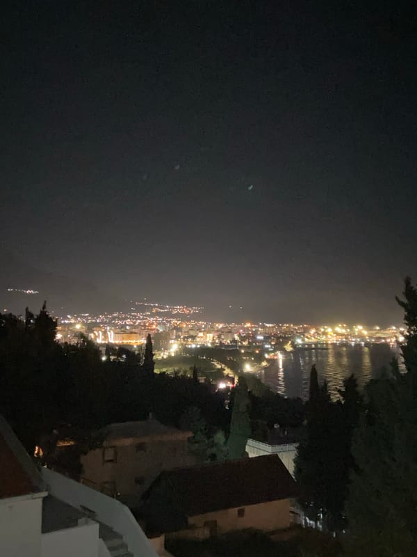 Evening balcony moment captured in illuminated Šušanj, Montenegro