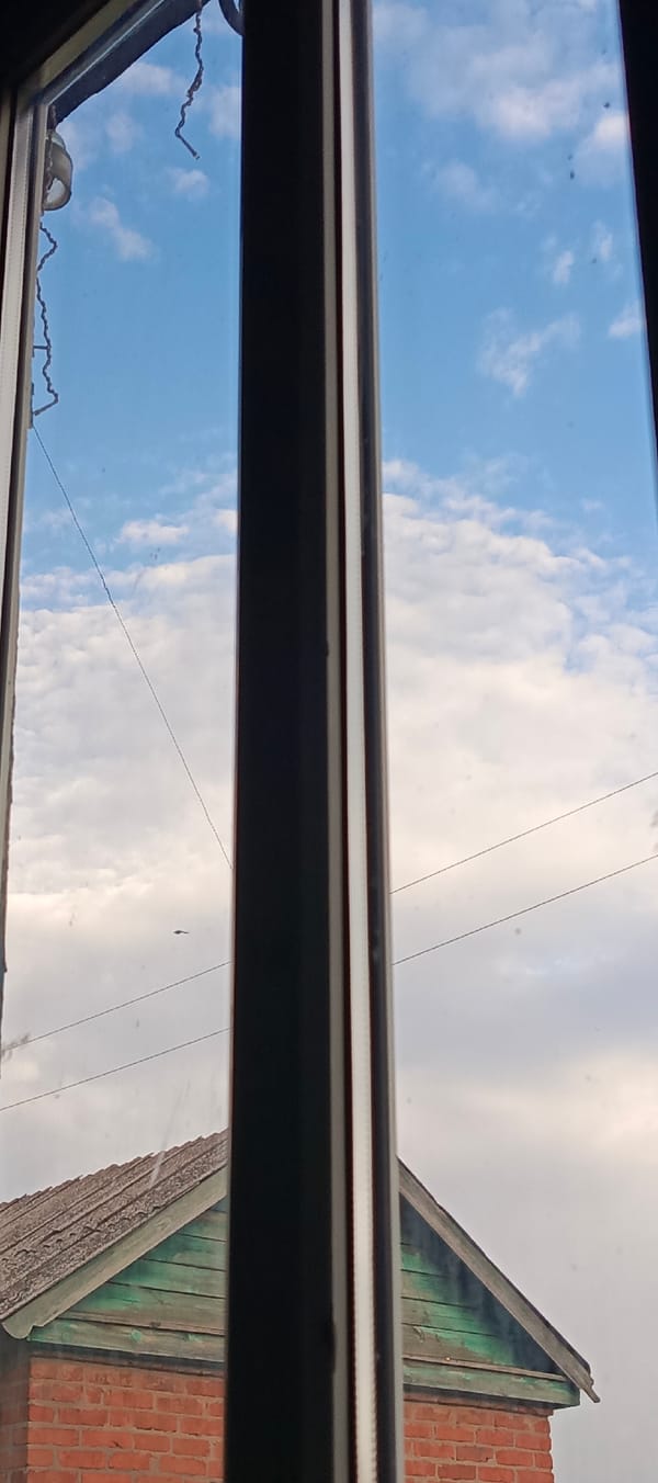 Cloudy sky through a divided window frame