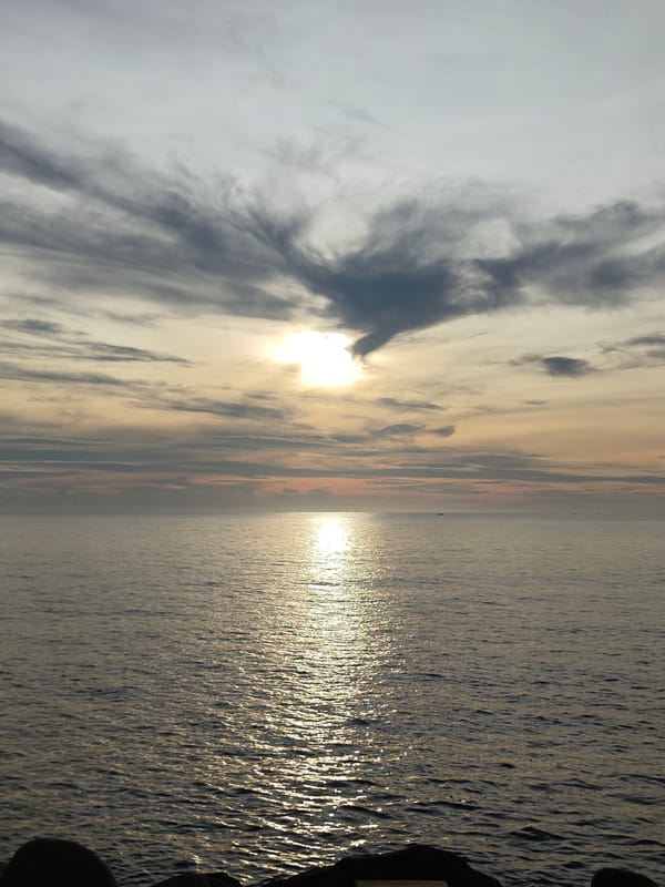 Sunset seascape with boats observed in Lhokseumawe, Indonesia