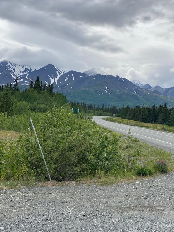 Roads, mountains, and a log cabin in remote Bear Creek, Canada