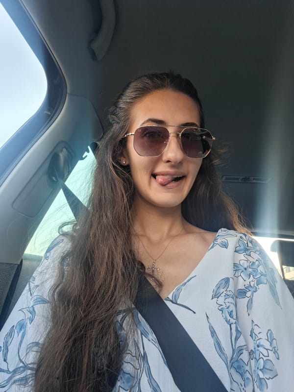 Car ride vibes with a teddy bear and red nails