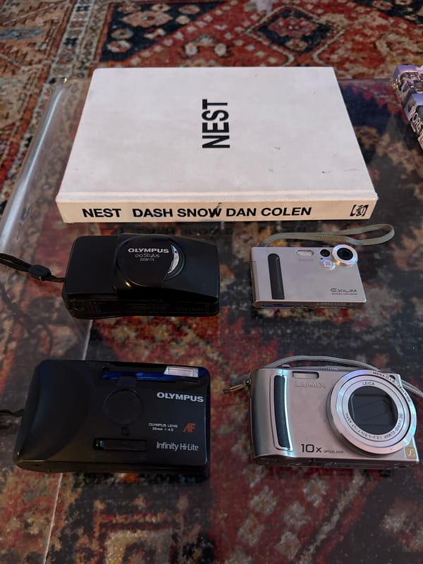 Cameras and book displayed on glass table in New York