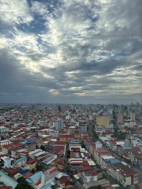 Aerial views over dense Khan Mean Chey rooftops under stormy skies