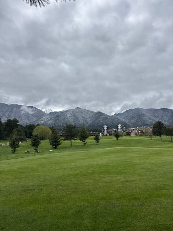 Golf resort landscape captured amid snowy mountains in Razlog