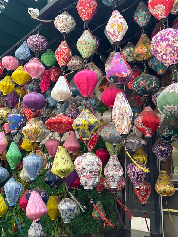 Tourist poses beneath colorful lantern display in Đà Nẵng