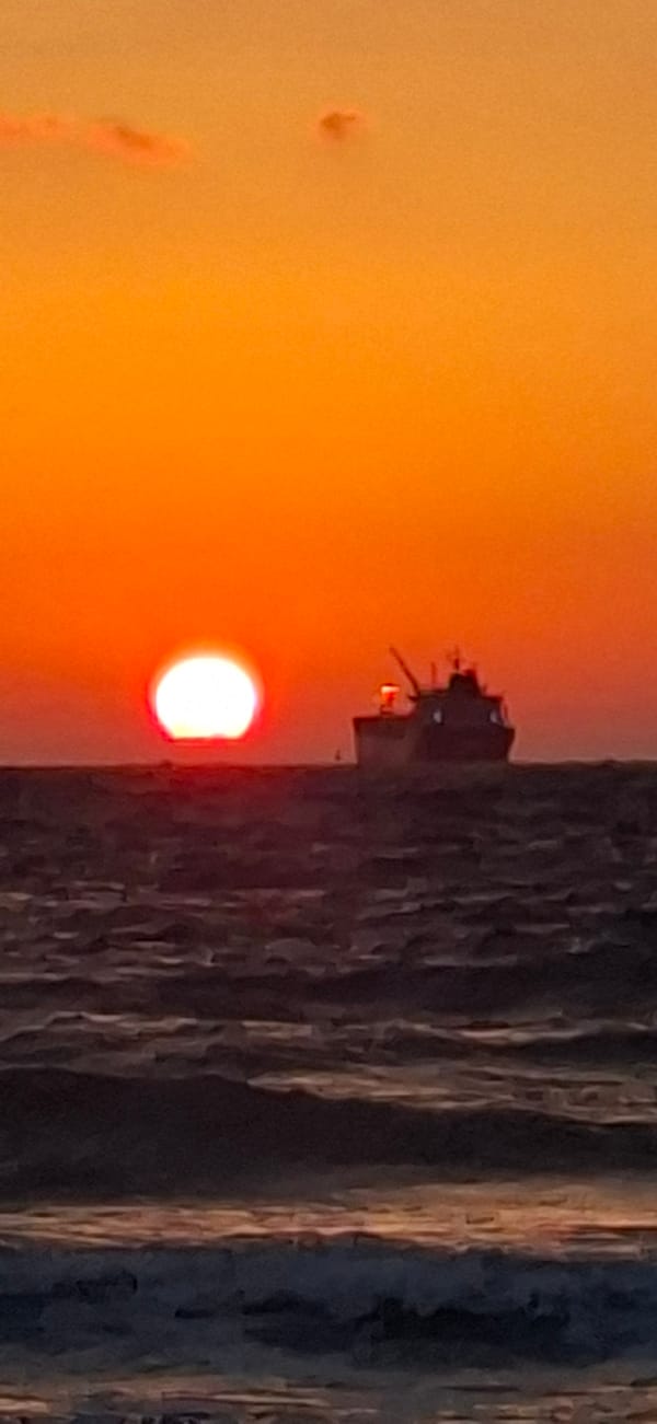 Haifa's Mediterranean shoreline at golden hour, midsummer