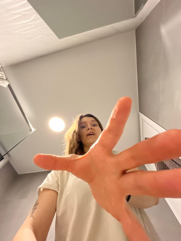 Woman reaches toward camera in indoor Limassol setting
