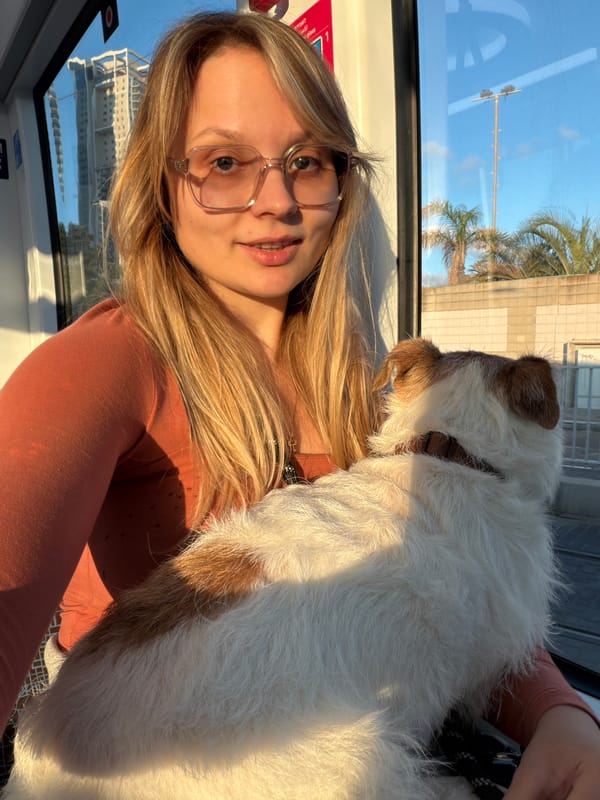 Woman travels with small dog on public transit in Bat Yam