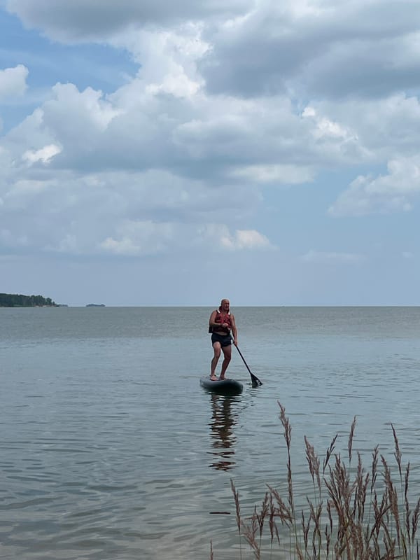 Paddleboarding on a calm Borovoe lake on a cloudy morning