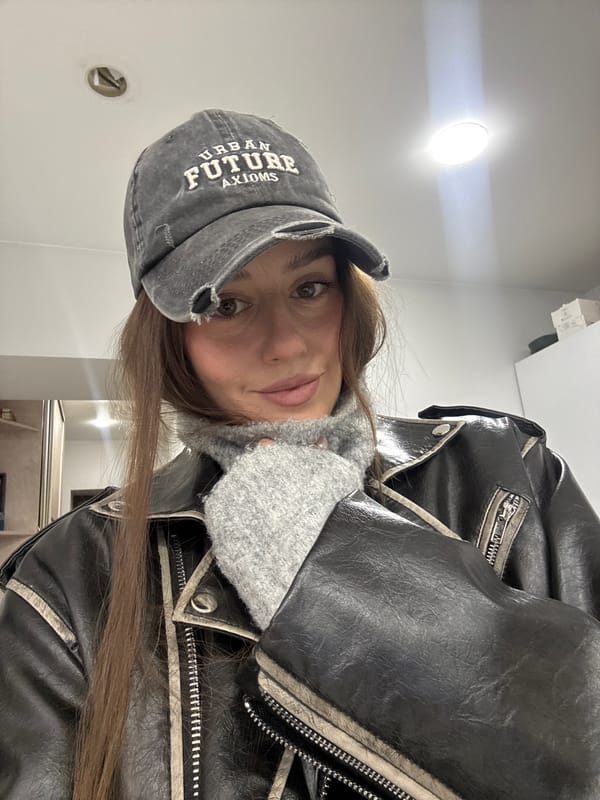 Woman takes selfies in Krasnoyarsk wearing urban-themed cap