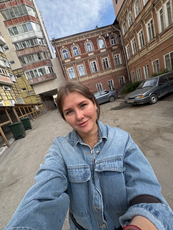 Woman photographs herself outside buildings in Perm, Russia
