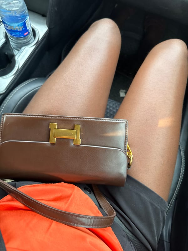 Person in orange shirt observed in car, Abuja area