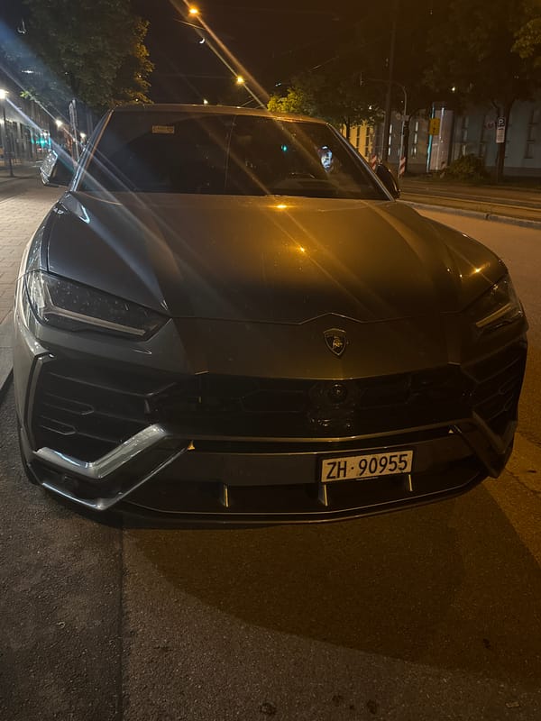 Gray Lamborghini Urus spotted parked on street at night