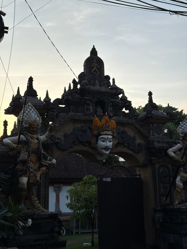 Tourist documents Balinese property with flowers, pool, traditional architecture