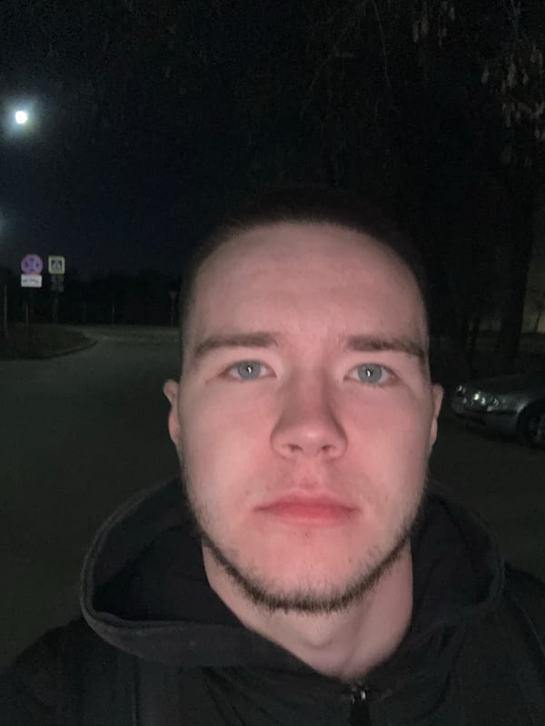 Young men gather at night near car in Kazan