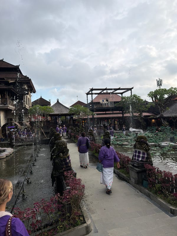 Tourist documents Ubud temple tour featuring lotus ponds, statues