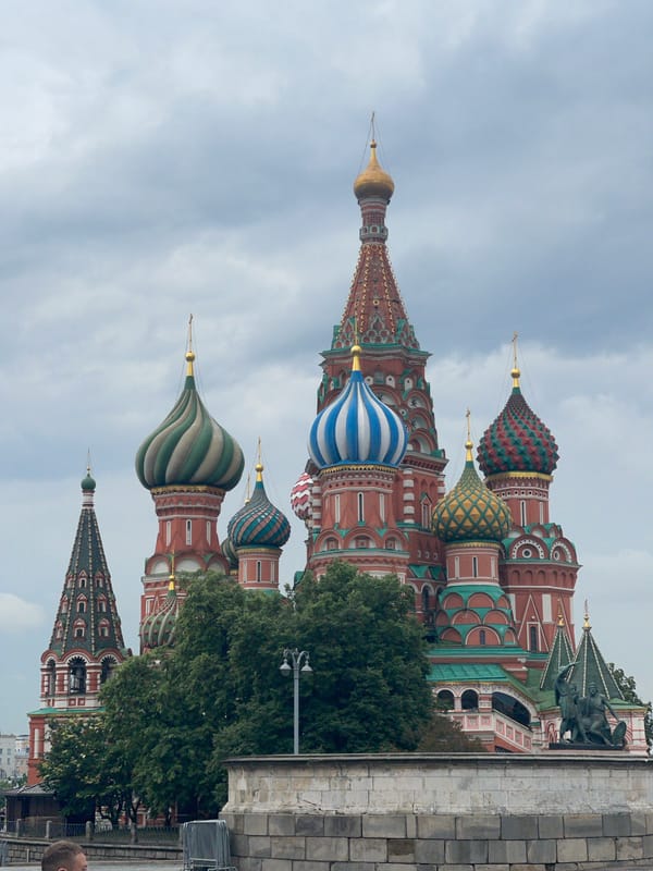 Tourist activity at Red Square landmarks on cloudy afternoon