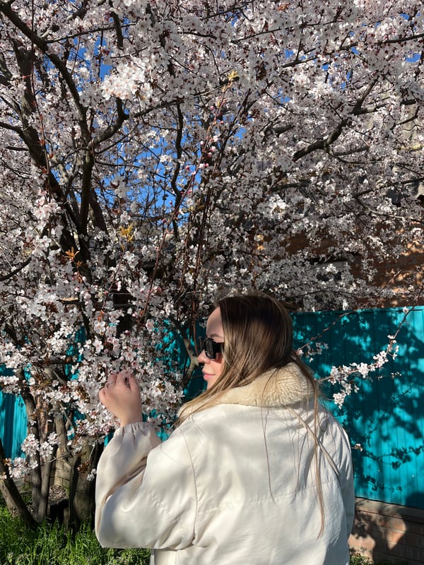 Woman poses with spring blossoms in Russian village photo session