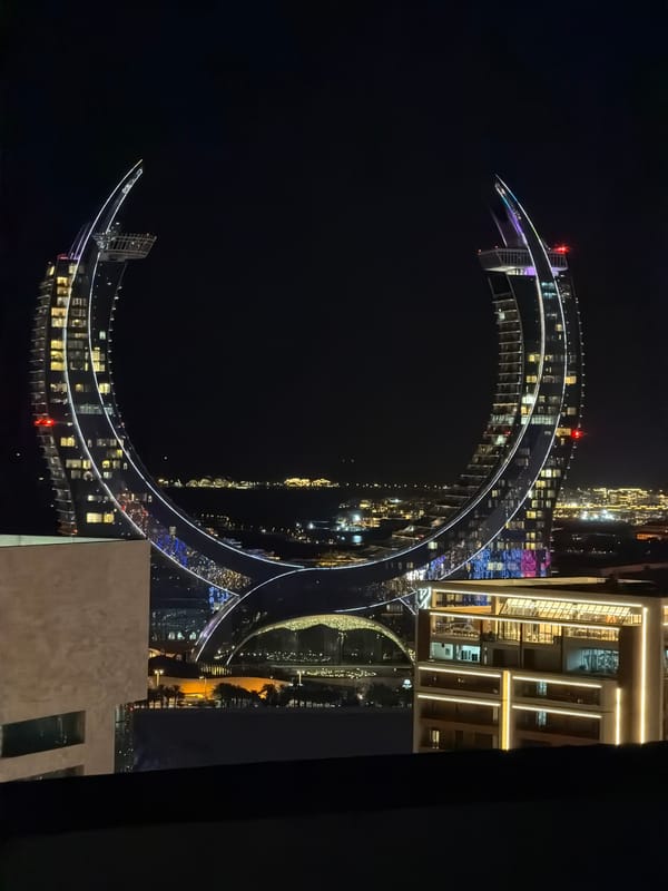 Nighttime views of illuminated Doha waterfront and Katara district