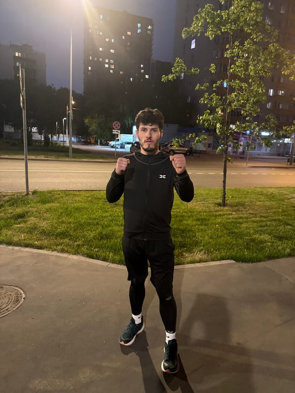 Man in athletic wear observed with clenched fists on Moscow sidewalk