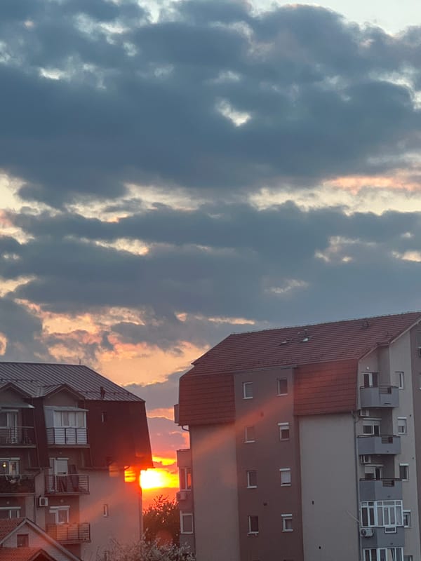 Dramatic sunset illuminates cloudy sky over Palilula, Serbia
