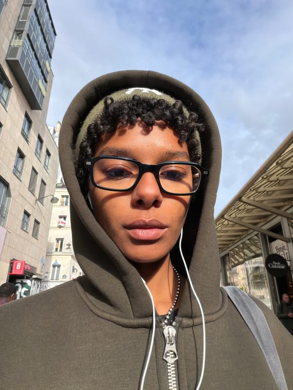 Person takes selfie among modern buildings in Paris