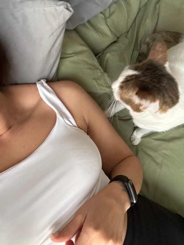 Woman and tabby cat share quiet moment in Dubai bedroom
