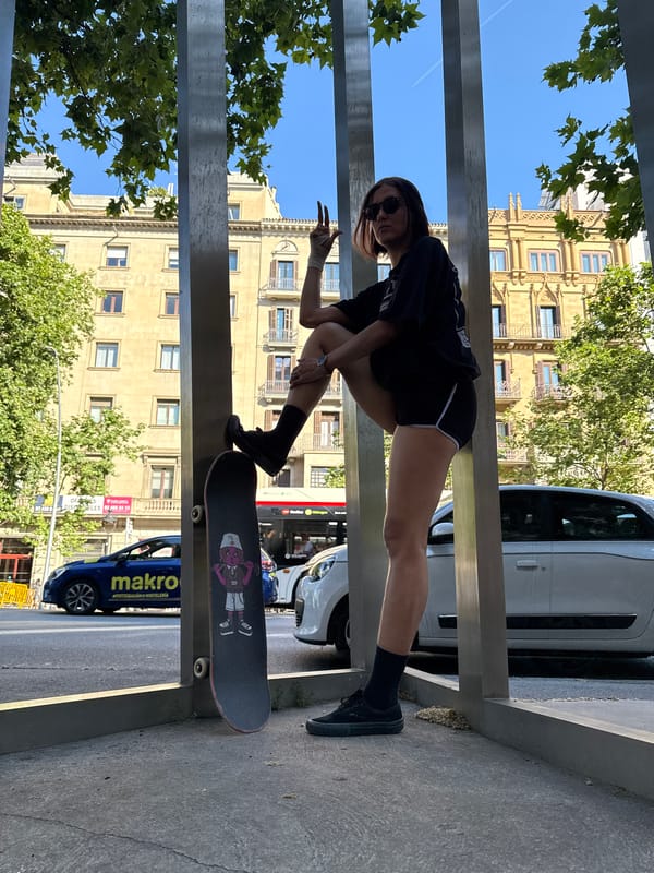 Woman skateboards on metal monument structure in Barcelona