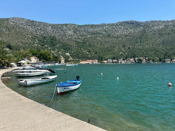 Calm morning on Dubrovnik's waterfront, boats and red rooftops