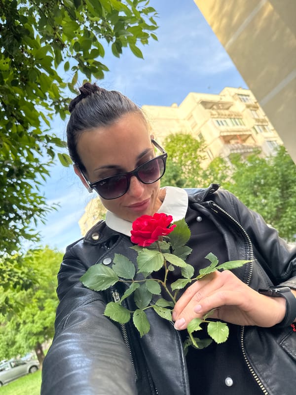 Woman films selfie with red rose in Pleven