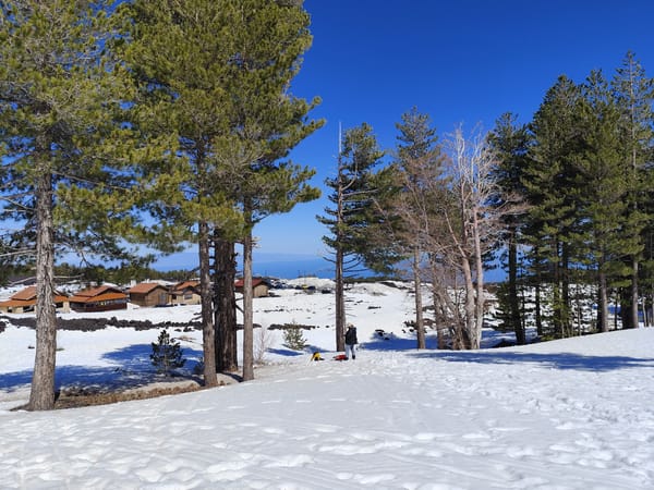 Spring snow blankets Linguaglossa as Mount Etna steams overhead