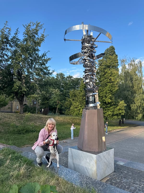Afternoon stroll around a Kyiv square with dogs, sculptures, and street details