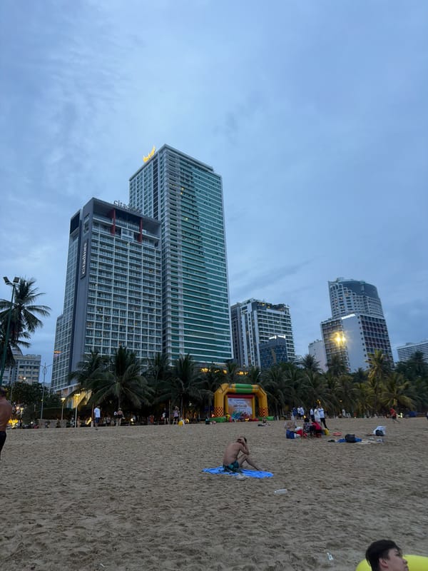 Busy morning on Nha Trang beach with events, construction, and crowds