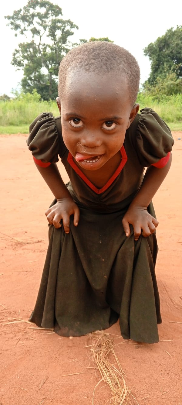 Aid worker distributes supplies to children in DRC villages
